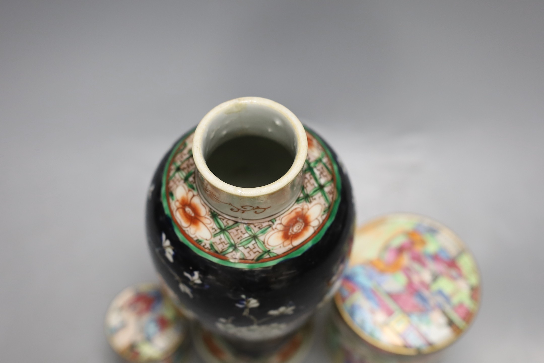 A Chinese famille noire vase, and two famille rose lidded pots, 19th century, Vase 12 cms high.